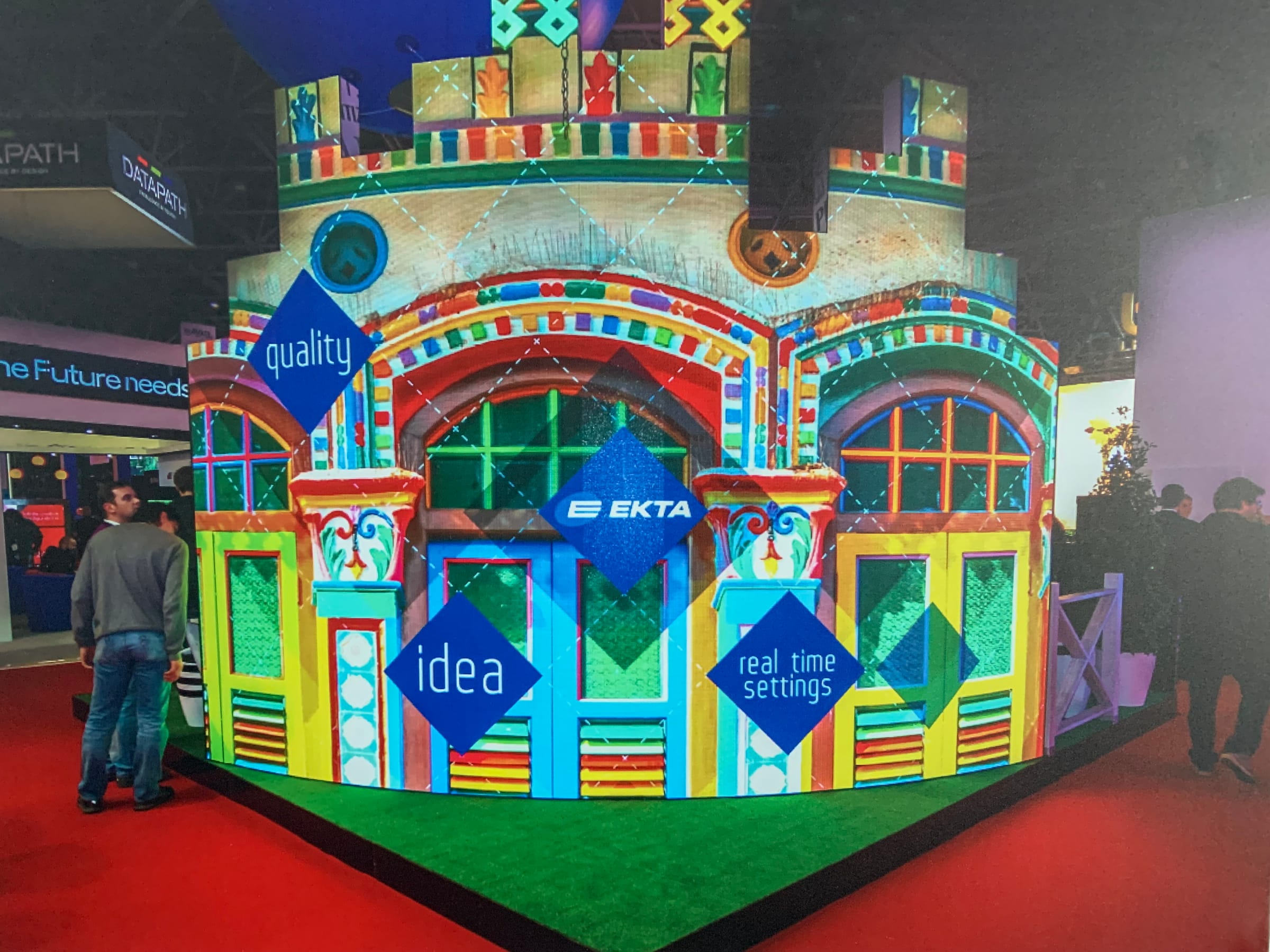 EKTA dvLED pavilion at ISE: a castle shaped, curved LED build with an irregular top, visitors looking on