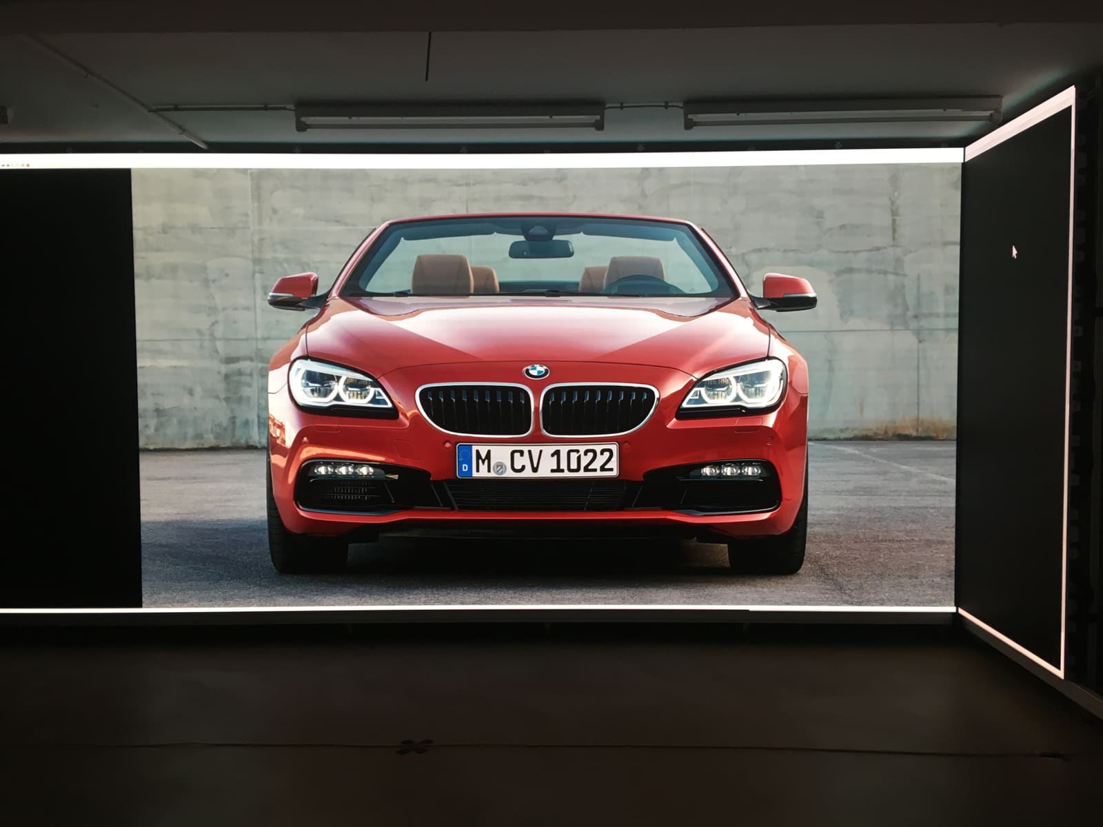 Red BMW convertible rendered at full width on a TRUE dvLED wall in our studio in Kassel, Germany