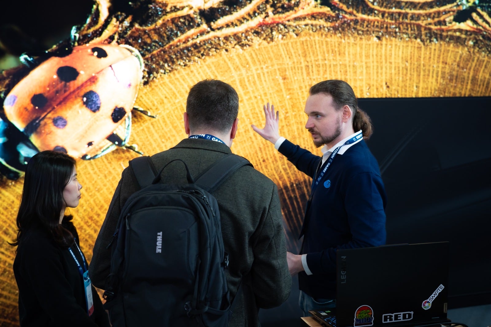 TRUE Performance engineer explaining a fine pitch dvLED wall to visitors on the TRUE trade show stand