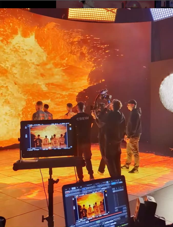 Crew reviewing a lava landscape on a TRUE dvLED volume on a monitor