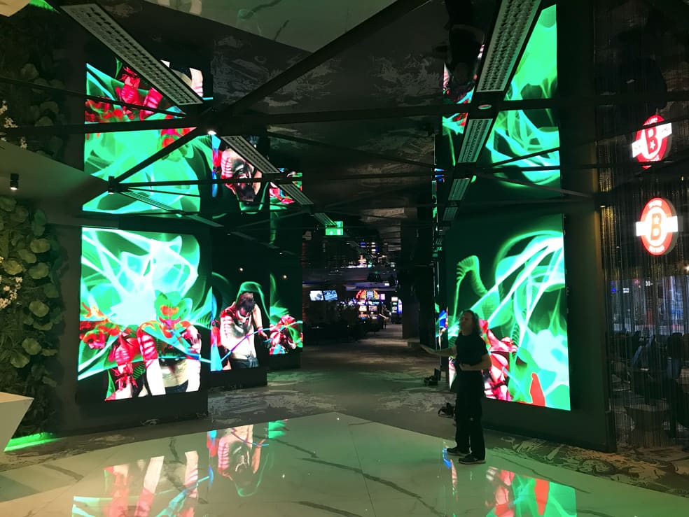 Casino entrance in Riga with TRUE dvLED columns showing green abstract content